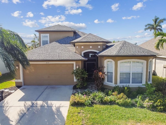 view of front of home with a garage and a front lawn