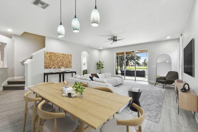 dining area with ceiling fan and light hardwood / wood-style flooring