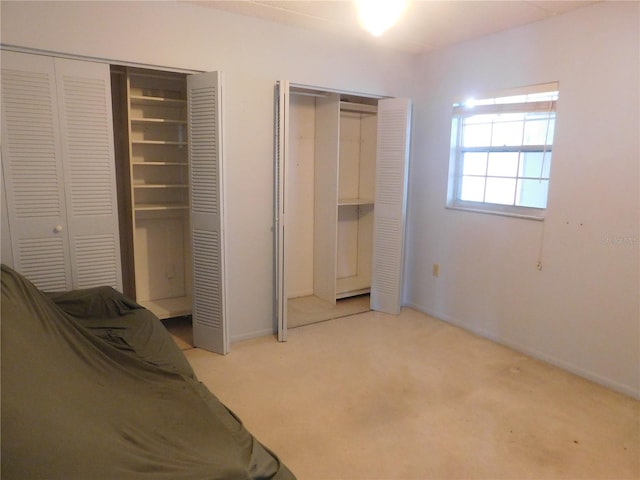 carpeted bedroom featuring two closets