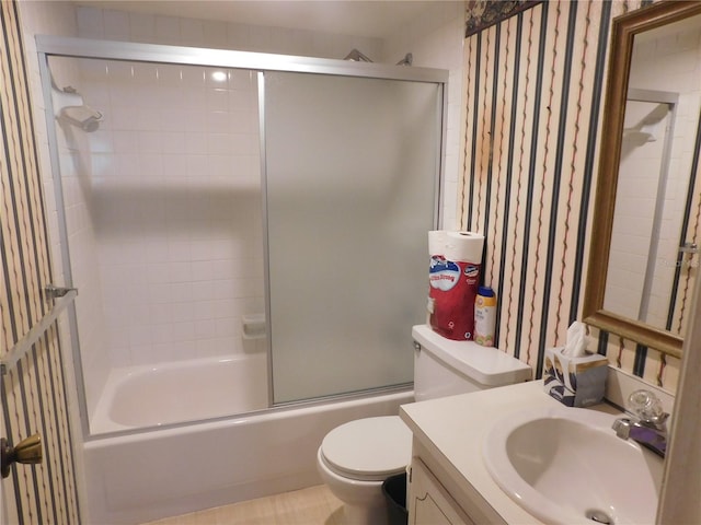 full bathroom featuring vanity, bath / shower combo with glass door, and toilet