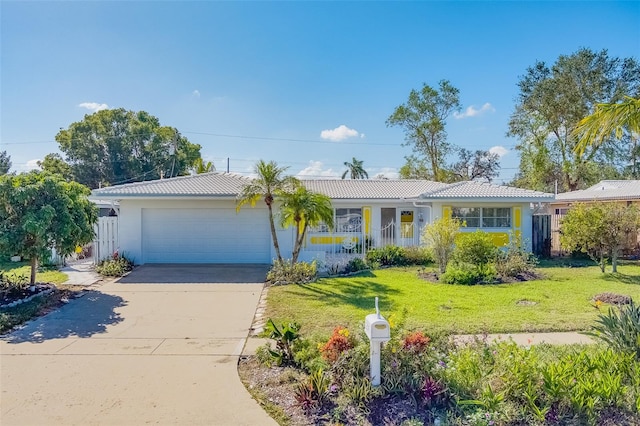 single story home featuring a garage and a front lawn