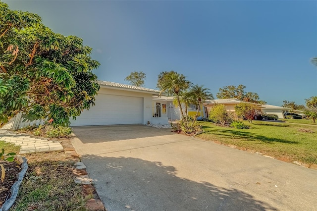 view of front of home featuring a garage and a front yard