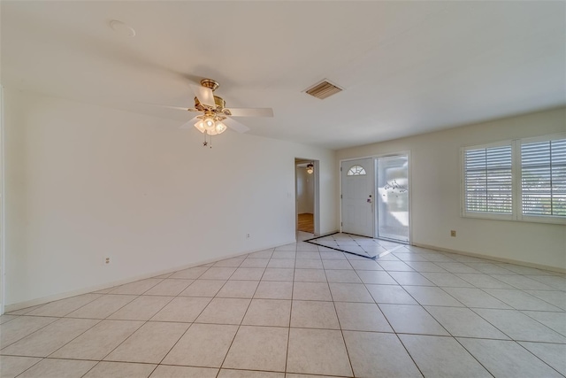 tiled empty room with ceiling fan