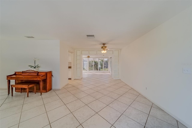 tiled empty room with ceiling fan