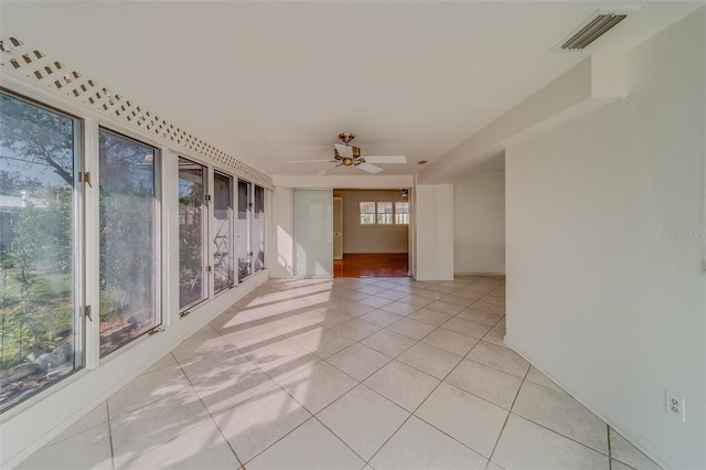 empty room featuring light tile patterned flooring and ceiling fan