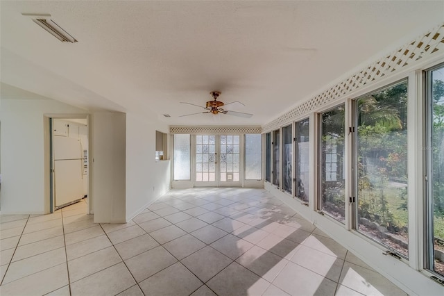 unfurnished sunroom with ceiling fan and french doors