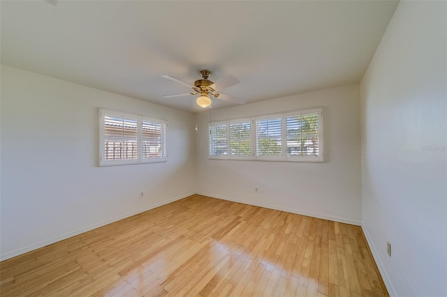 empty room with light hardwood / wood-style floors and ceiling fan