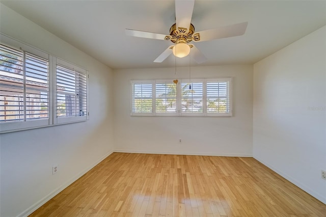 unfurnished room with light wood-type flooring, a healthy amount of sunlight, and ceiling fan