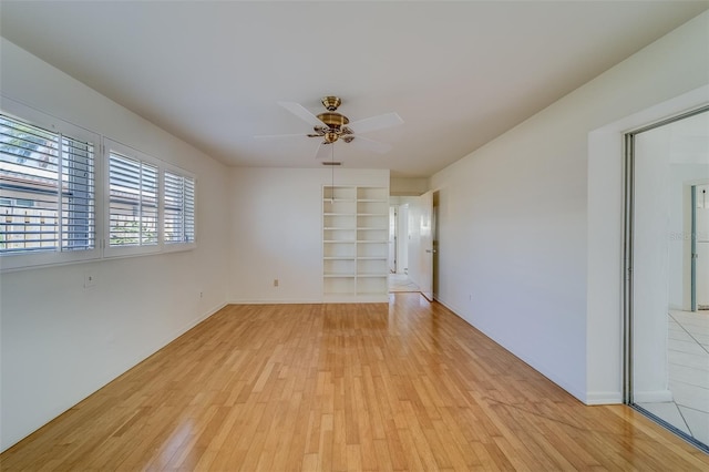 unfurnished room with ceiling fan and light hardwood / wood-style flooring