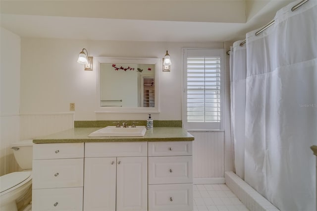 bathroom with toilet, vanity, and walk in shower