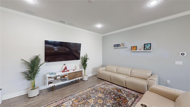 living room featuring hardwood / wood-style floors, a textured ceiling, and crown molding