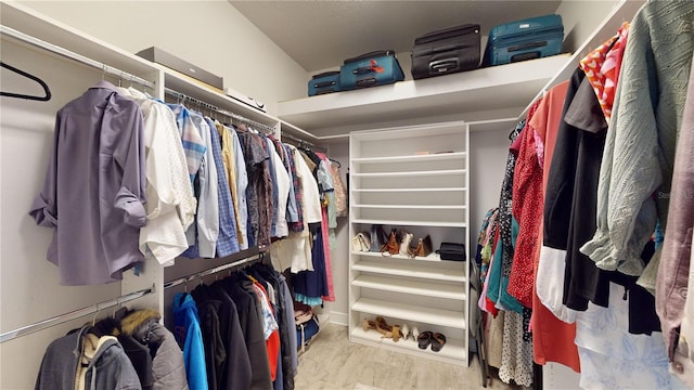 spacious closet with light hardwood / wood-style flooring