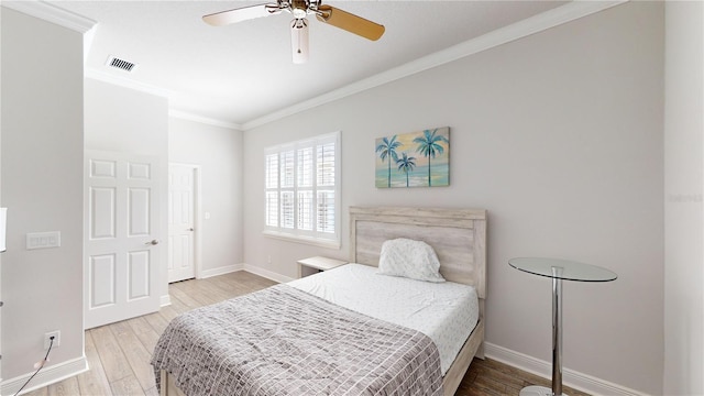 bedroom with ornamental molding, wood-type flooring, and ceiling fan