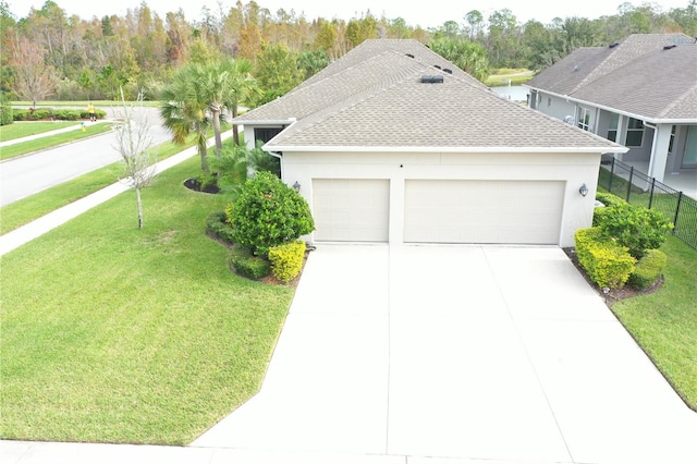 view of front of house featuring a garage and a front yard