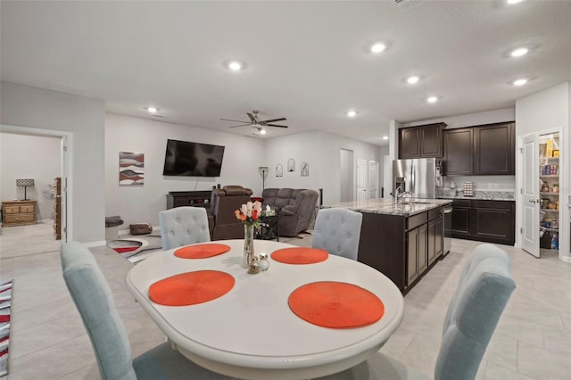 dining space with ceiling fan and sink