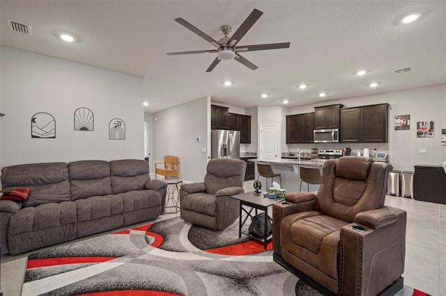 living room featuring ceiling fan and sink