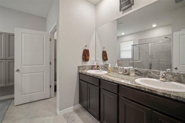 bathroom with tile patterned flooring, a shower with door, and vanity