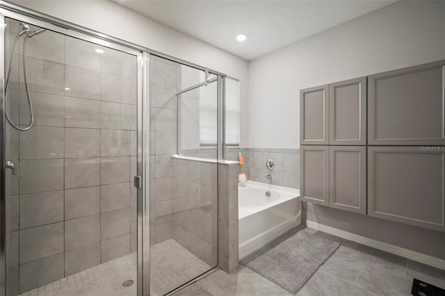 bathroom with independent shower and bath and tile patterned flooring