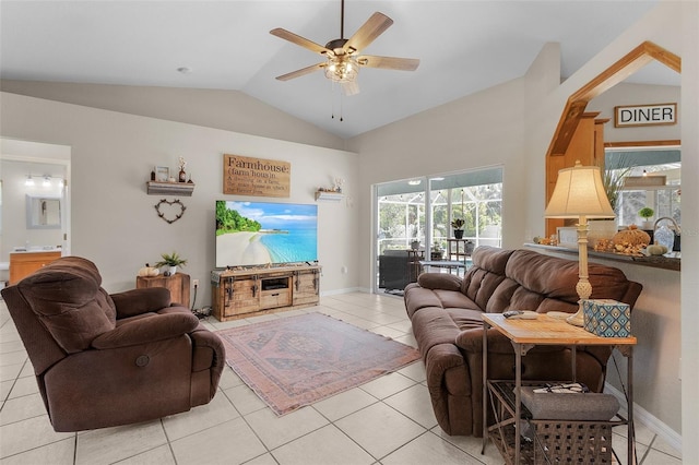 living room with ceiling fan, light tile patterned floors, and vaulted ceiling