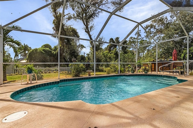 view of pool with a patio and a lanai