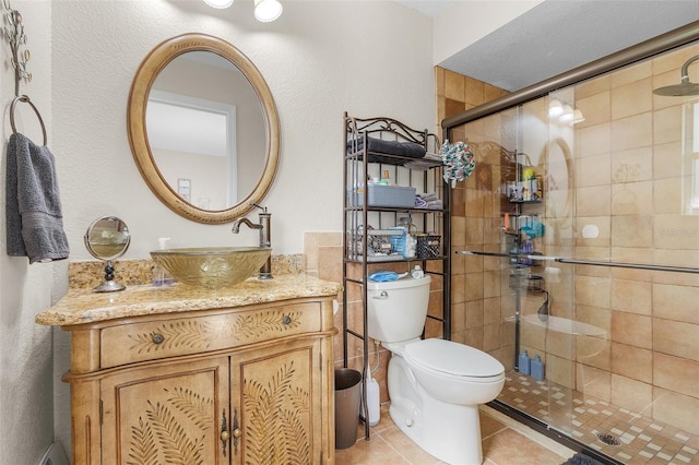 bathroom with vanity, toilet, and an enclosed shower