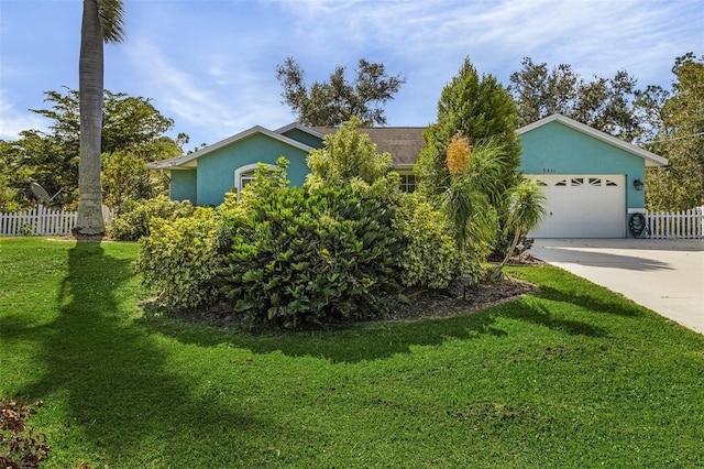 ranch-style home with a front yard and a garage