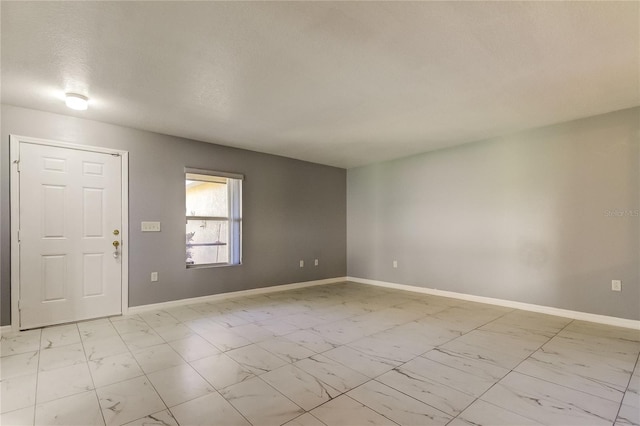 foyer entrance with a textured ceiling