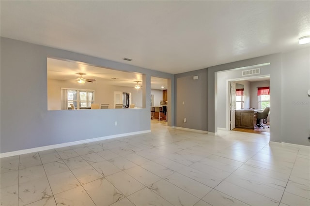 5220 Butterfly Shell Dr, Apollo Beach, FL 33572 - unfurnished living room featuring light marble finish flooring, baseboards, and a ceiling fan