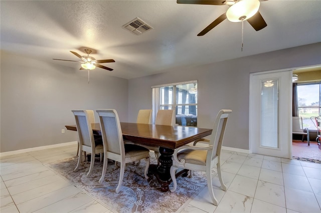 5220 Butterfly Shell Dr, Apollo Beach, FL 33572 - dining room featuring a ceiling fan, light marble finish flooring, and baseboards
