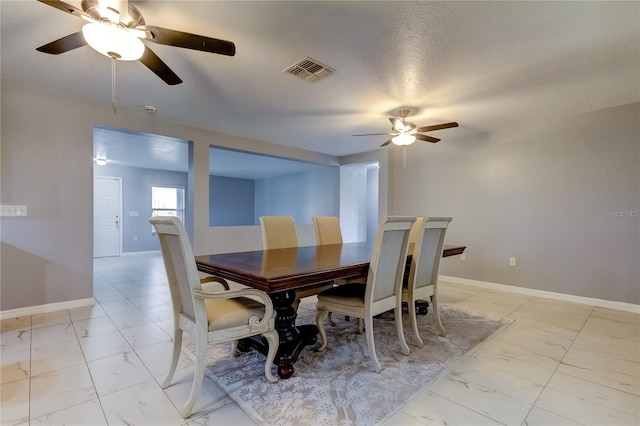 dining space featuring a textured ceiling and ceiling fan