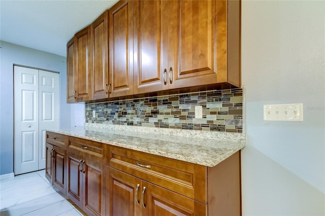 kitchen with tasteful backsplash and light stone counters