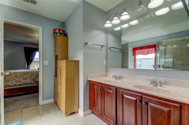 bathroom with tile patterned floors, vanity, and an enclosed shower