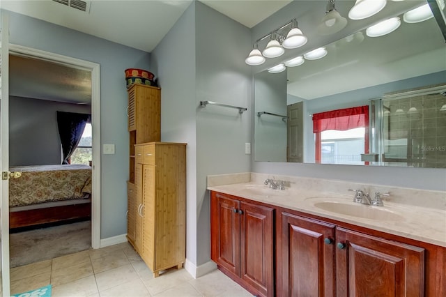 5220 Butterfly Shell Dr, Apollo Beach, FL 33572 - ensuite bathroom with plenty of natural light, double vanity, tile patterned flooring, and baseboards