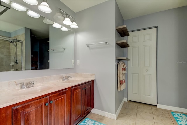 bathroom with tile patterned flooring, vanity, and a shower with door