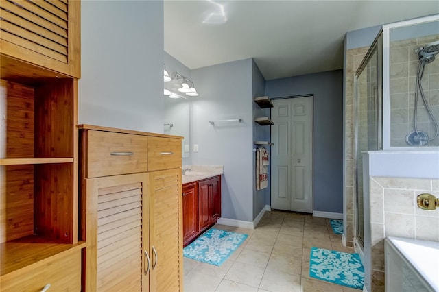 bathroom featuring tile patterned flooring, vanity, and a shower with shower door