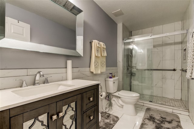 bathroom with tile patterned flooring, a shower with door, toilet, and tile walls