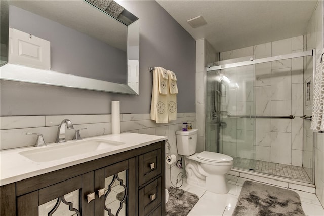 5220 Butterfly Shell Dr, Apollo Beach, FL 33572 - full bath with toilet, vanity, a stall shower, tile walls, and a wainscoted wall