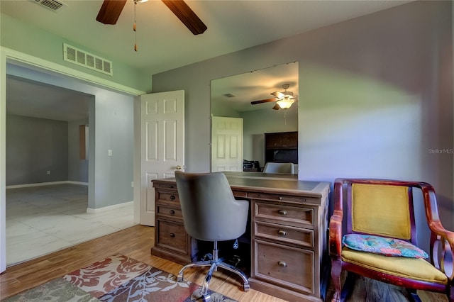 home office featuring light wood-type flooring and ceiling fan