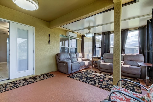 sunroom featuring an AC wall unit, ceiling fan, and beam ceiling