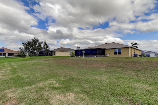 5220 Butterfly Shell Dr, Apollo Beach, FL 33572 - view of grassy yard featuring a sunroom and central AC unit