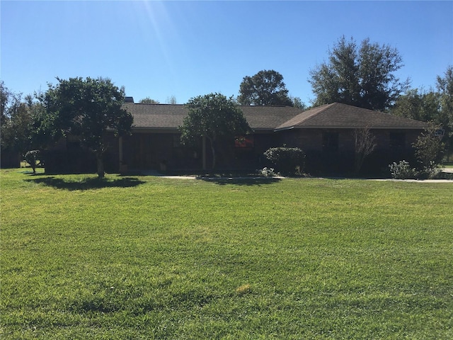 ranch-style home with a front lawn