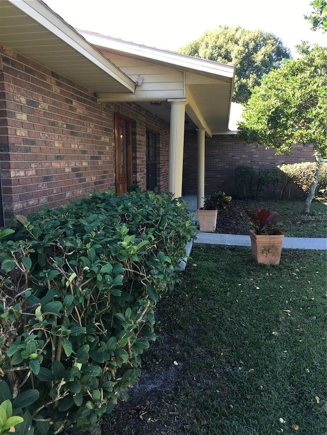 entrance to property with a lawn