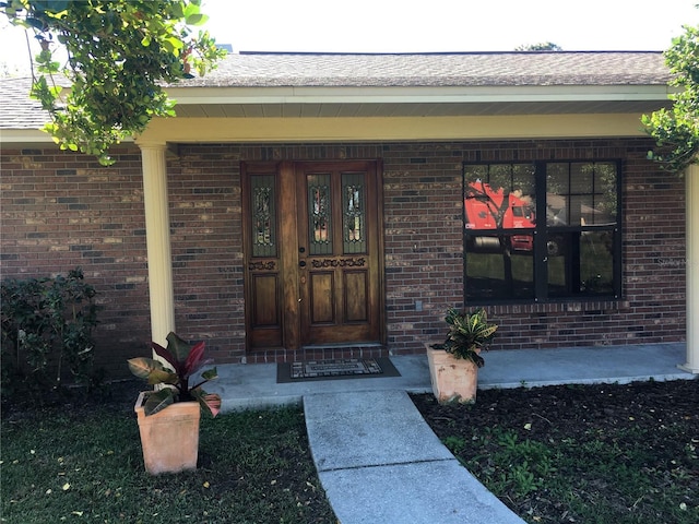 view of exterior entry featuring a porch