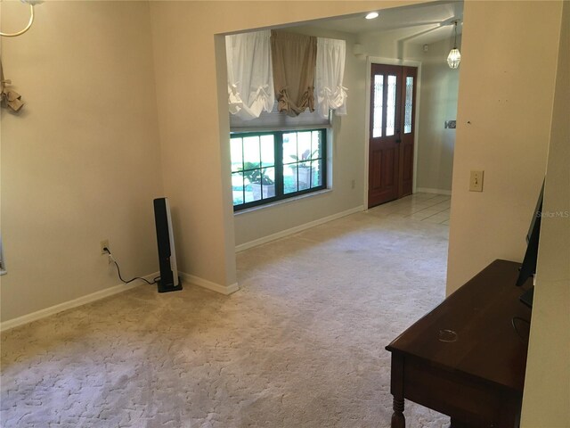 unfurnished living room with light carpet