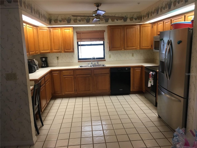 kitchen featuring ceiling fan, light tile patterned floors, sink, and black appliances