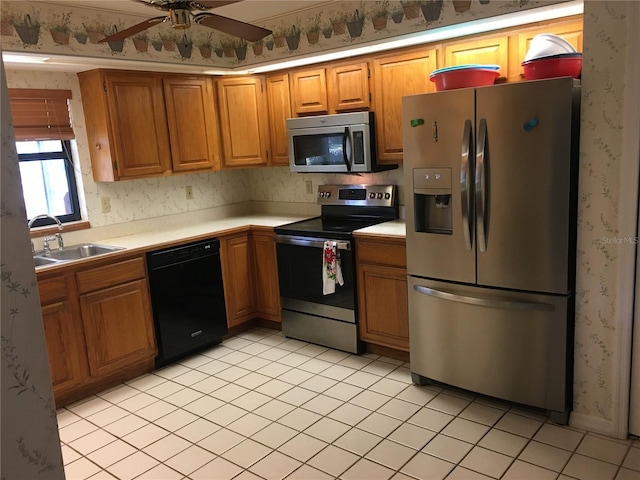 kitchen with ceiling fan, appliances with stainless steel finishes, and sink