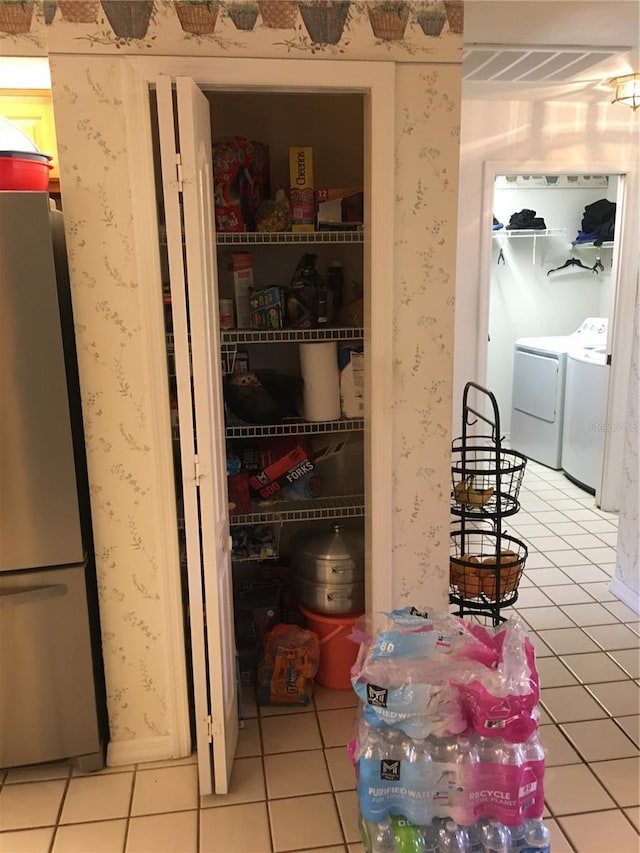 pantry with washing machine and clothes dryer