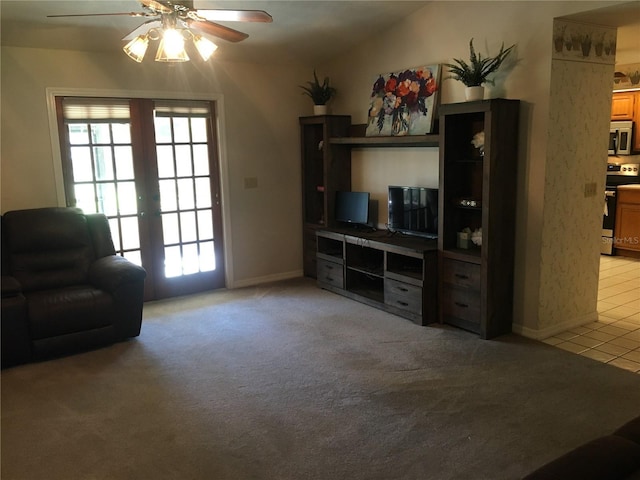 carpeted living room with lofted ceiling, french doors, and ceiling fan