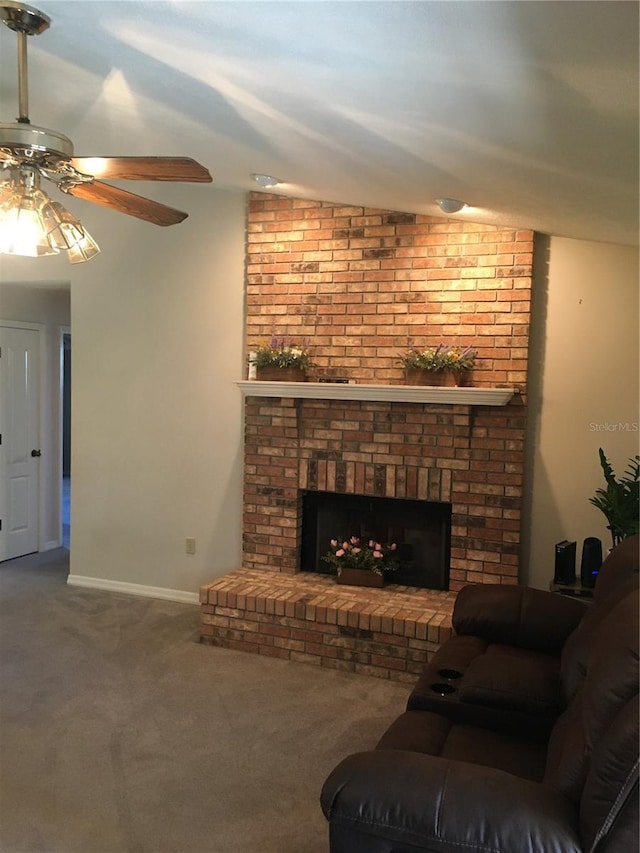 living room with ceiling fan, a fireplace, and carpet floors