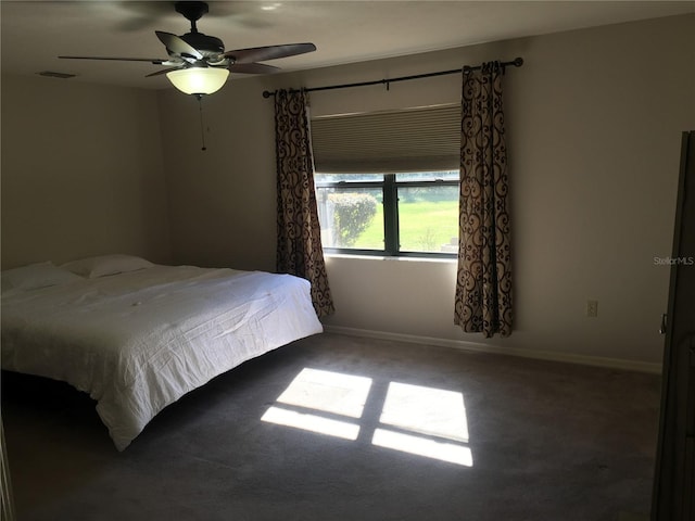 unfurnished bedroom featuring dark carpet and ceiling fan